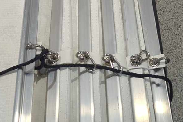 retractable shade sail snap hooks showing back of shade