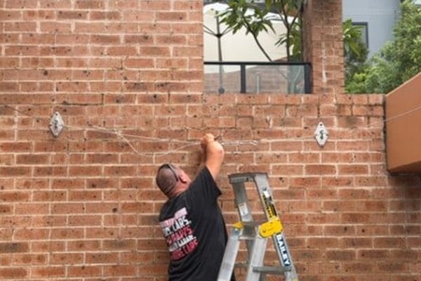 installing wire into brick work